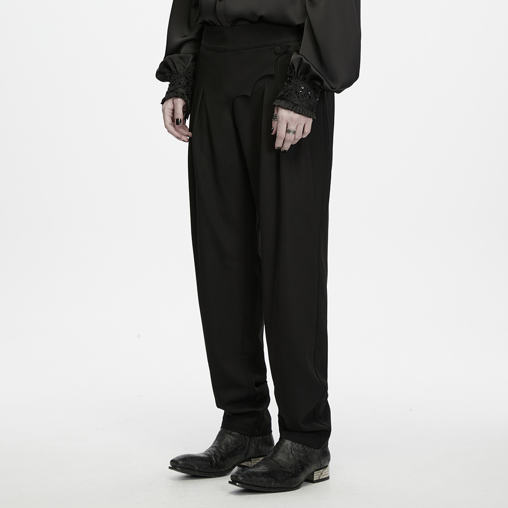 Side profile view of a model wearing the Ink Ruins Batwing Pleated Trousers showing the relaxed seat and neat ankle taper